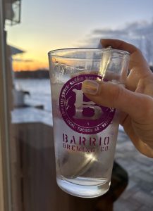 Hand holding glass of electrolyte water during sunrise ritual